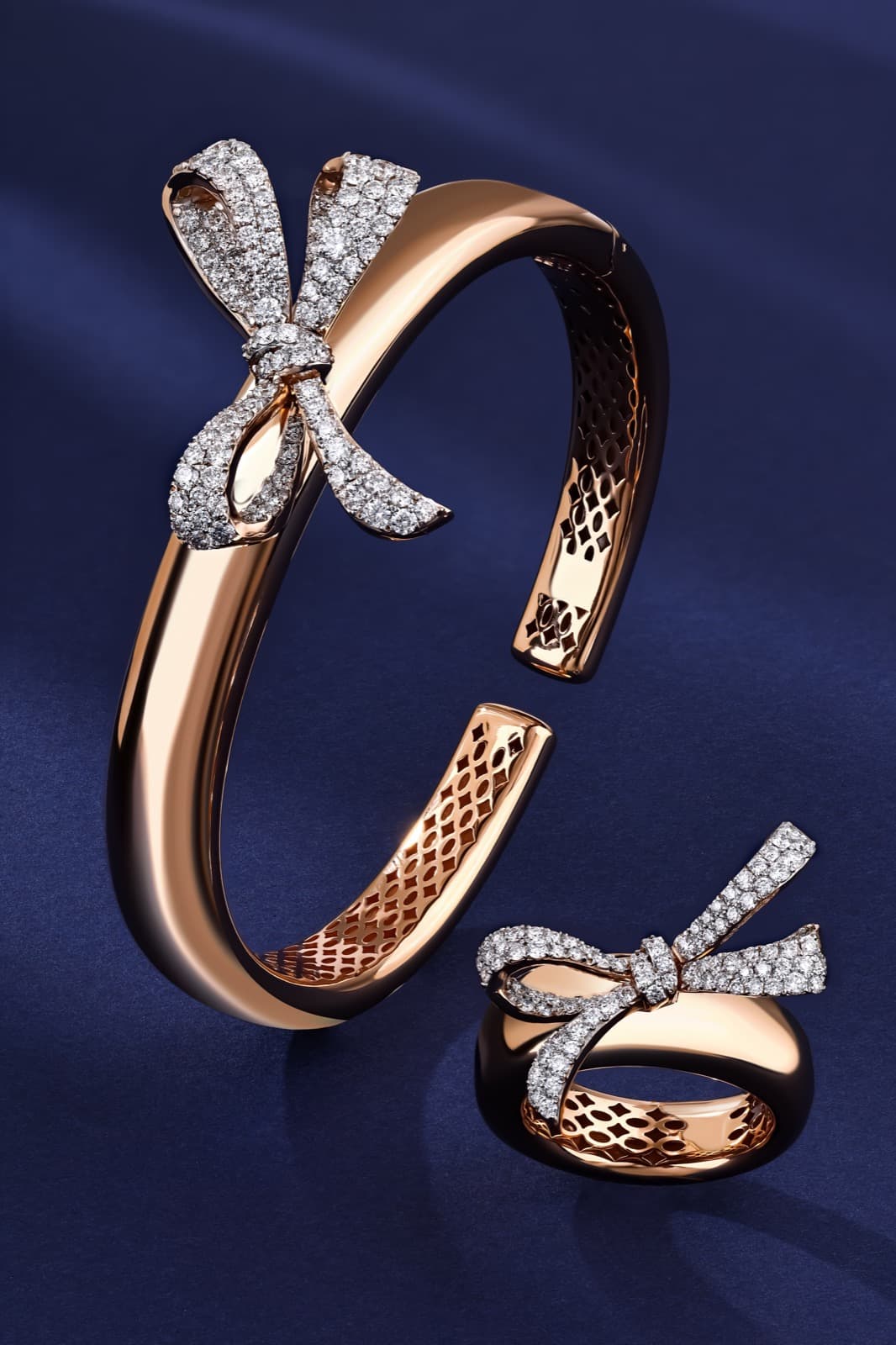 Fiocco rose gold bow bangle and ring on deep blue